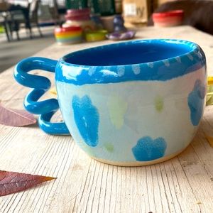 Drippy floral mug with coil handle